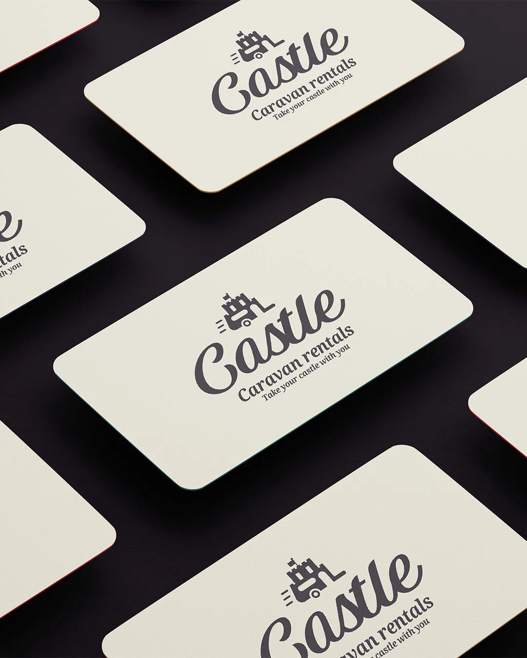 The castle caravans logo displayed on an array of business cards