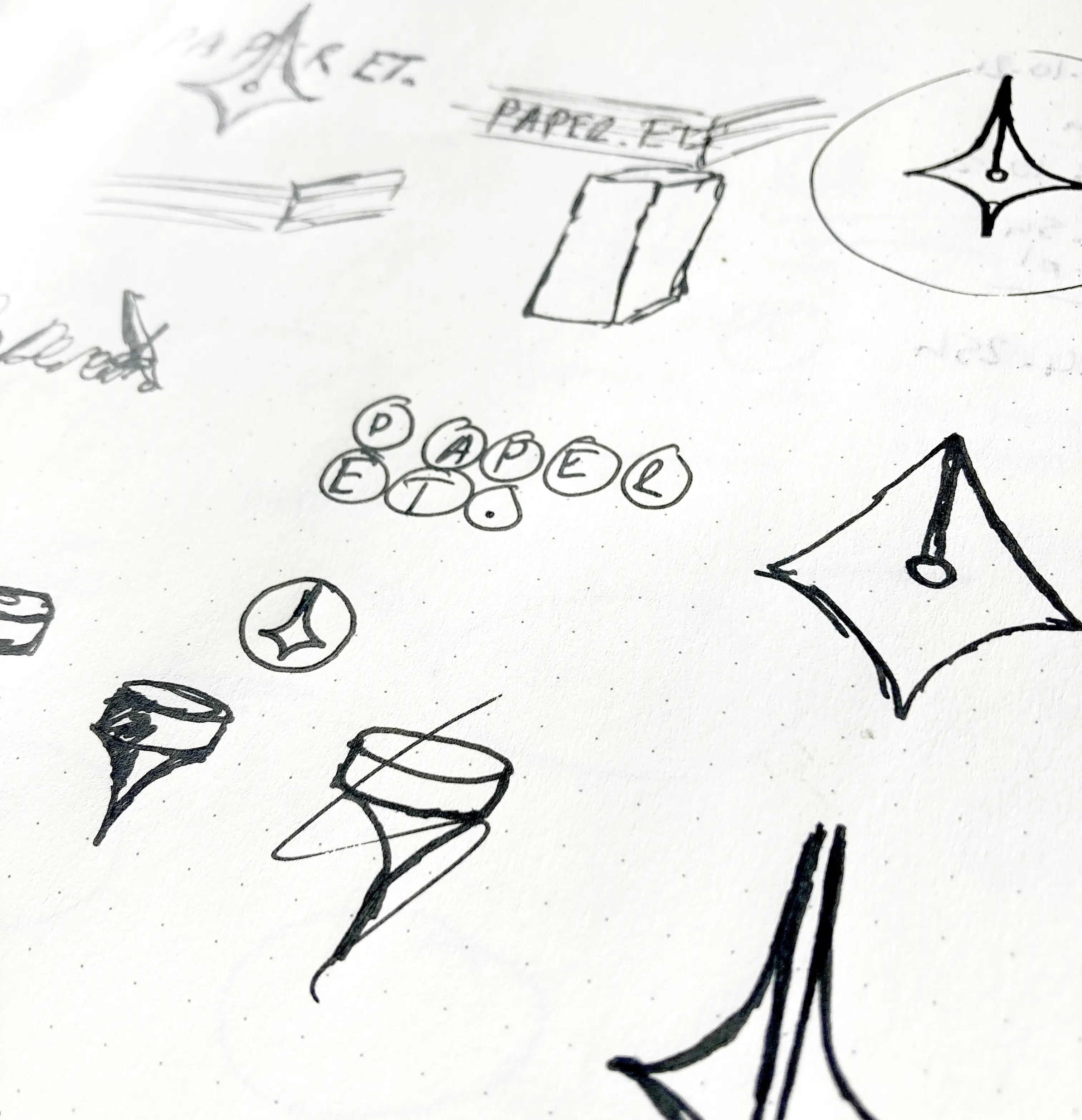 Sketches on a piece of paper of logo concepts